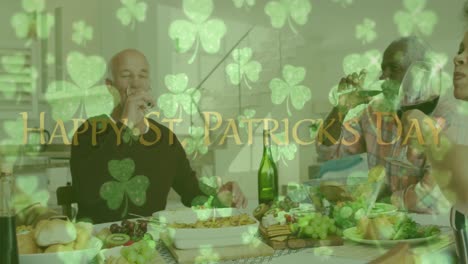 Animation-of-happy-st-patrick's-day-text-with-clover-leaves-over-friends-celebrating-with-wine