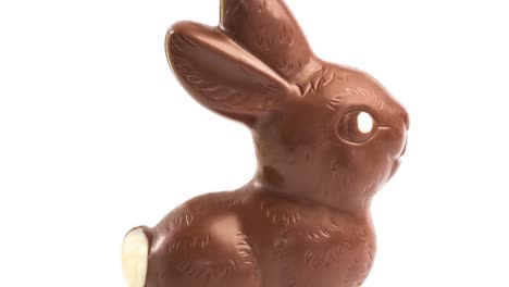 Animation-of-easter-chocolate-bunny-moving-over-white-background