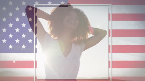 American-flag-with-glitch-effect-against-african-american-woman-smiling-at-the-beach