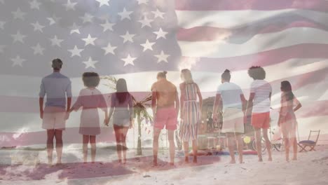 Amerikanische-Flagge-Weht-Vor-Der-Rückansicht-Einer-Gruppe-Von-Freunden,-Die-Am-Strand-Springen