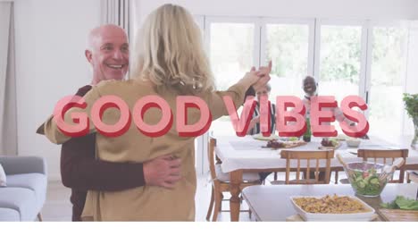 Good-vibes-text-against-caucasian-senior-couple-dancing-together-at-home
