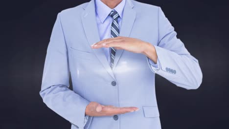 Animation-of-glowing-spot-of-light-between-businesswoman-hands-on-grey-background