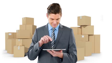 Animation-of-businessman-using-tablet-with-stacks-of-boxes-on-white-background