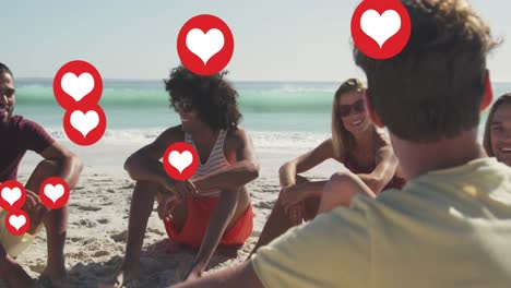 Animation-of-social-media-heart-icons-over-smiling-group-of-friends-on-beach