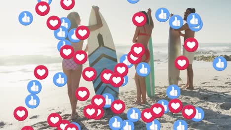Animation-of-social-media-like-and-love-cons-over-friends-holding-surfboards-on-beach