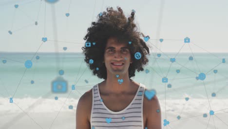 Animation-of-network-of-digital-icons-over-happy-man-smiling-on-beach