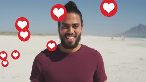 Animation-Von-Social-Media-Symbolen-Mit-Roten-Herzen-Und-Liebe-über-Einem-Lächelnden-Mann-Am-Strand