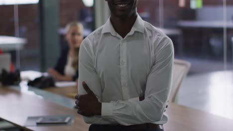 Portrait-of-african-american-businessman-in-meeting-room-looking-to-camera-smiling