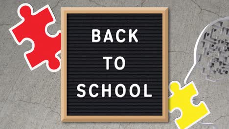 Animation-of-puzzles-falling-over-back-to-school-text-on-black-letter-board