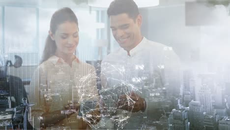 Animation-of-globe-spinning-over-businessman-and-businesswoman-using-tablet-over-cityscape