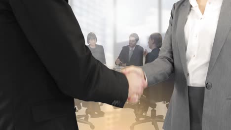 Animation-of-businessman-and-businesswoman-shaking-hands-over-group-of-businesspeople-in-office