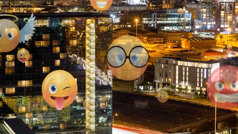 Animation-of-emoji-icons-flying-up-over-cityscape-at-night