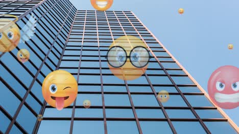 Animation-of-emoji-icons-flying-up-over-modern-office-building-against-blue-sky