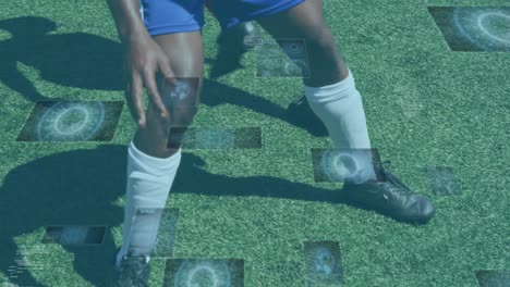 Animation-of-scopes-and-data-processing-on-screens-over-male-football-players-during-game