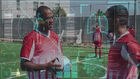 Digital-interface-with-medical-data-processing-against-two-male-soccer-players-talking-on-grass-turf