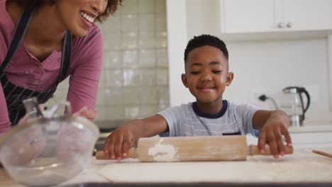 African-american-mother-and-son-baking-together-in-the-kitchen-at-home