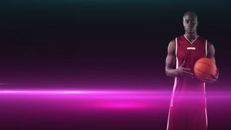 Animation-of-african-american-male-basketball-player-holding-ball-on-dark-background-with-pink-light