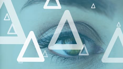 Animation-of-white-triangles-flying-up-over-woman's-eye