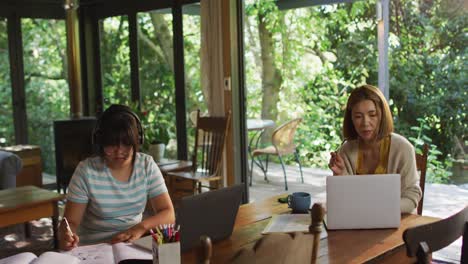 Asian-mother-and-daughter-learning-and-working-using-laptops