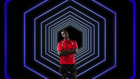 Animation-of-pointing-african-american-rugby-player-over-concentric-purple-hexagons-moving-on-black