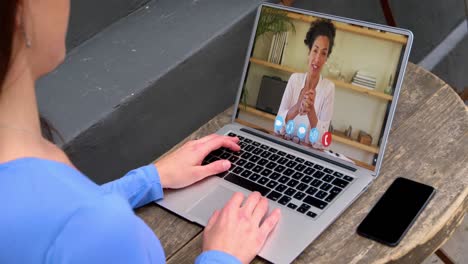 Caucasian-woman-having-a-video-call-on-laptop-with-female-office-colleague