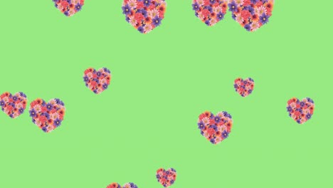 Animation-of-flower-filled-heart-shapes-floating-over-light-green-background