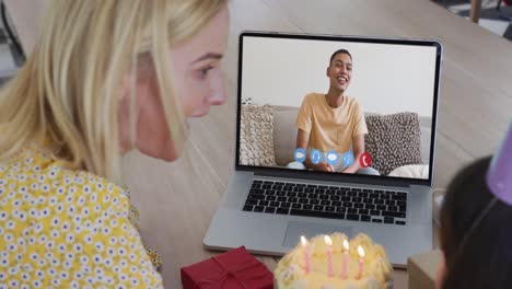 Caucasian-mother-and-daughter-celebrating-birthday-on-video-call-on-laptop-at-home