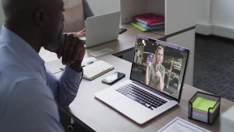 African-american-senior-man-having-a-video-call-with-female-colleague-on-laptop-at-office