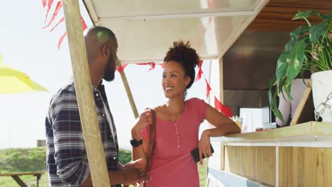 African-american-couple-talking-to-each-other-deciding-order-at-the-food-truck