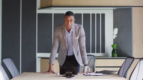 African-american-businessman-talking-on-video-call-in-conference-room-in-modern-office