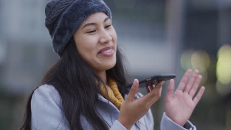 Asian-woman-talking-on-smartphone-and-smiling