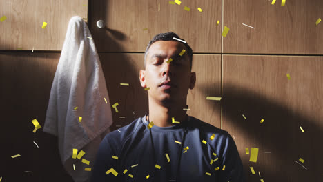 Animation-of-confetti-falling-over-football-player-in-changing-rooms