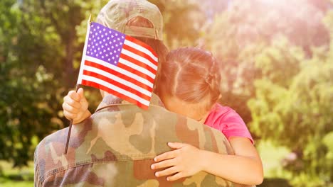Animation-of-male-soldier-embracing-his-daughter-with-american-flag-over-trees