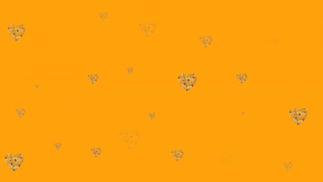 Animation-of-flower-hearts-moving-in-hypnotic-motion-on-orange-background