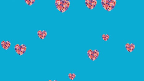 Animation-of-flower-hearts-moving-in-hypnotic-motion-on-blue-background