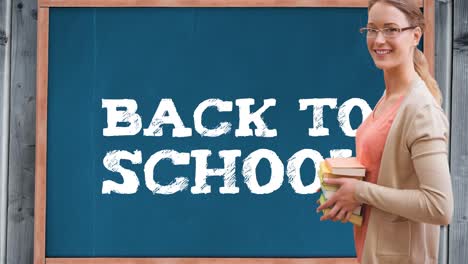 Animation-of-text-back-to-school-on-blue-chalkboard-with-smiling-female-school-teacher-holding-books