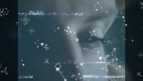 Animation-of-play-digital-interface-on-screen-with-molecules-over-woman's-face