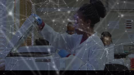 Animation-of-network-of-connections-over-scientists-working-in-laboratory