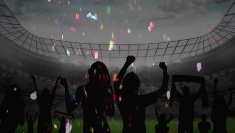 Colorful-confetti-falling-over-silhouette-of-fans-cheering-and-sports-stadium-in-background
