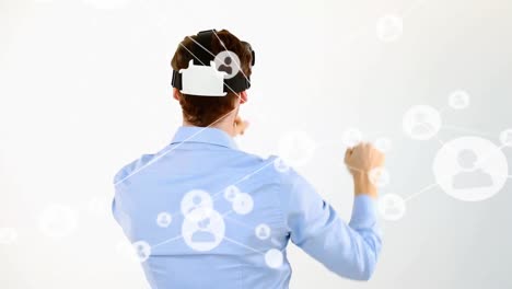 Animation-of-network-of-connections-with-people-icons-over-businessman-wearing-vr-headset