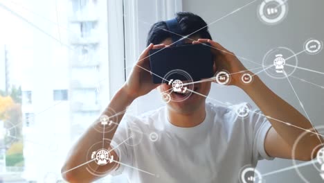 Animation-of-network-of-connections-with-icons-over-man-wearing-vr-headset