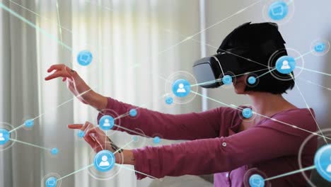 Animation-of-network-of-connections-with-icons-over-woman-wearing-vr-headset