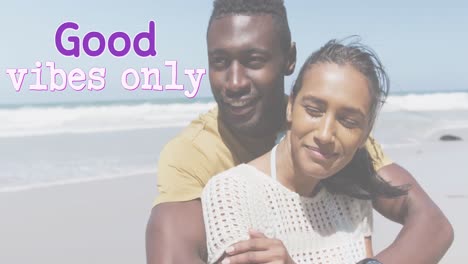 Animation-of-the-words-good-vibes-only-in-purple-over-happy-couple-embracing-on-beach