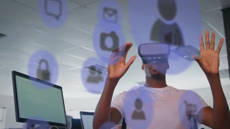 Blaue-Digitale-Symbole-Schweben-Vor-Einem-Afroamerikanischen-Geschäftsmann,-Der-Zu-Hause-Ein-VR-Headset-Trägt