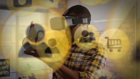 Mehrere-Digitale-Symbole-Schweben-Vor-Einem-Afroamerikanischen-Geschäftsmann,-Der-Im-Büro-Ein-VR-Headset-Trägt