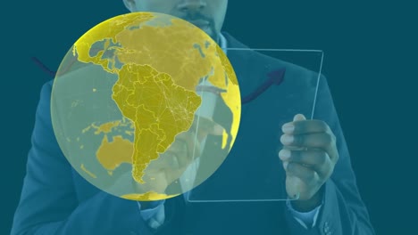 Animation-of-globe-over-businessman-using-tablet