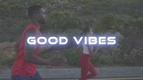 Animation-of-the-words-good-vibes-in-white-over-couple-exercising-running-on-mountain-road