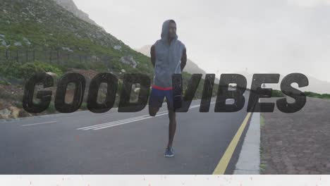 Animation-of-the-words-good-vibes-only-in-black-over-man-exercising-on-mountain-road