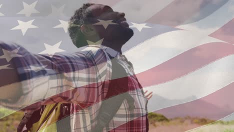 Animation-Einer-Amerikanischen-Flagge,-Die-Sich-über-Einen-Mann-Bewegt,-Der-Seine-Arme-Am-Strand-Ausbreitet