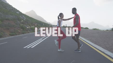 Animation-of-the-words-level-up-written-in-white-over-couple-exercising-on-mountain-road
